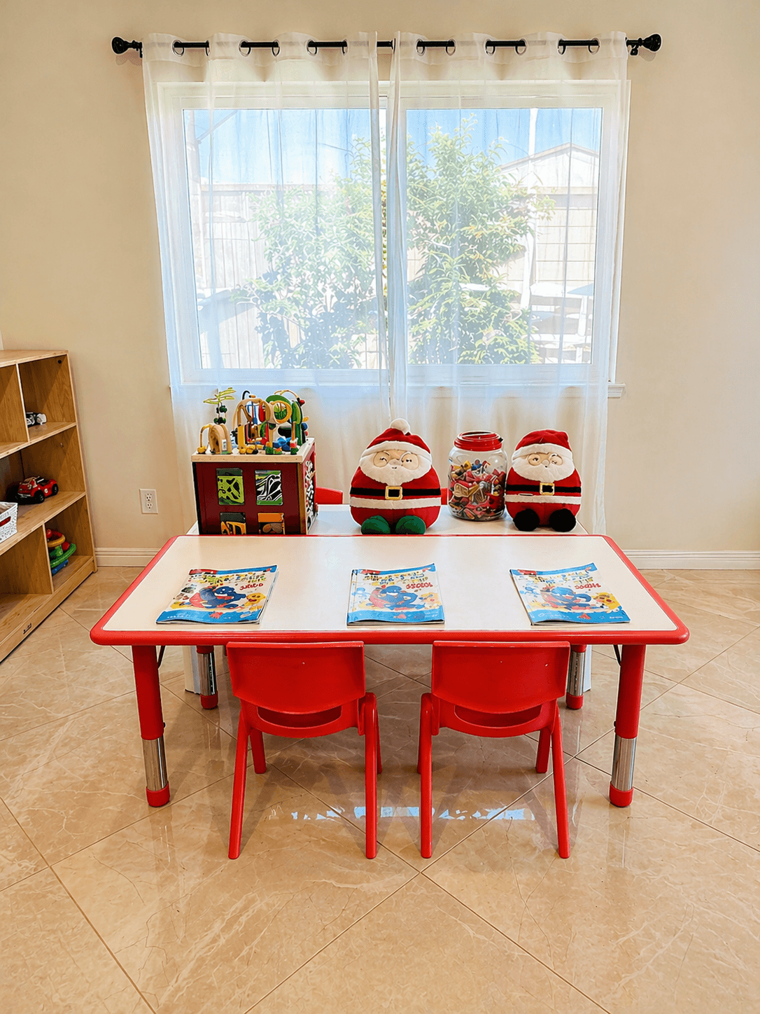 Bright and clean classroom with red table and chairs at Little Hearts LA in Hacienda Heights